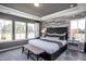Spacious bedroom with large windows and wood-like accent wall at 295 Broomside Ave, Raleigh, NC 27603