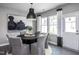 Modern dining area with round table, gray chairs, and access to backyard at 295 Broomside Ave, Raleigh, NC 27603
