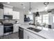 Modern kitchen with white cabinets, granite countertops, and stainless steel appliances at 295 Broomside Ave, Raleigh, NC 27603