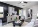 Living area with dark shiplap wall, gray furniture, and large windows at 295 Broomside Ave, Raleigh, NC 27603