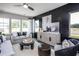 Spacious living room with gray sofas, dark accent wall, and large windows at 295 Broomside Ave, Raleigh, NC 27603