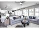 Open concept living room with gray sofas and access to kitchen and dining at 295 Broomside Ave, Raleigh, NC 27603