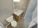 Simple bathroom with toilet and vanity at 311 Burnette St, Durham, NC 27707