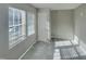 Bright bedroom with two windows, neutral walls, and carpeted floor at 311 Burnette St, Durham, NC 27707