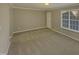 Spacious carpeted bedroom with large window at 311 Burnette St, Durham, NC 27707
