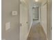 Hallway with gray walls and carpet, leading to other rooms at 311 Burnette St, Durham, NC 27707