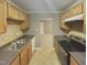 Kitchen with wood cabinets, stainless steel appliances, and tile backsplash at 311 Burnette St, Durham, NC 27707