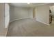 Carpeted living room with window and door at 311 Burnette St, Durham, NC 27707