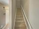 Modern staircase with carpeted steps and neutral-colored walls at 311 Burnette St, Durham, NC 27707