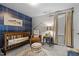 Bedroom featuring a crib, armchair, and plaid wall at 38 Hiddenbrook Ct, Angier, NC 27501