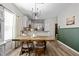 Bright dining area with a rustic wooden table and modern chandelier at 38 Hiddenbrook Ct, Angier, NC 27501