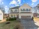 Two-story house with gray siding, a large garage, and a well-manicured lawn at 38 Hiddenbrook Ct, Angier, NC 27501