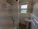 Simple bathroom with tub, shower, and pedestal sink at 4503 Hopson Rd, Morrisville, NC 27560