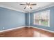 Spacious bedroom with hardwood floors and a large window at 4616 Transept Ct, Holly Springs, NC 27540