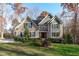 Two-story house with gray and beige siding, shutters, and landscaping at 4616 Transept Ct, Holly Springs, NC 27540