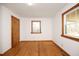 Simple bedroom with hardwood floors and two windows at 540 Patterson Dr, Chapel Hill, NC 27516