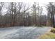 Gravel driveway with gate leading into a wooded area at 540 Patterson Dr, Chapel Hill, NC 27516