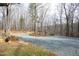 Large gravel driveway winding through a wooded area at 540 Patterson Dr, Chapel Hill, NC 27516