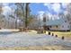 White farmhouse with a green metal roof, stone accents, and a gravel driveway at 540 Patterson Dr, Chapel Hill, NC 27516