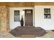Inviting front porch with stone accents and a dark brown front door at 540 Patterson Dr, Chapel Hill, NC 27516