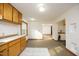 Open kitchen with view into adjacent living area and wood flooring at 540 Patterson Dr, Chapel Hill, NC 27516