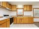 Bright kitchen features wood cabinets, white appliances, and tiled floors at 540 Patterson Dr, Chapel Hill, NC 27516