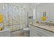 Clean bathroom with granite vanity and floral shower curtain at 5503 Rutherford Close, Pittsboro, NC 27312