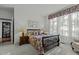 Bright bedroom with a floral bedspread and ample natural light at 5503 Rutherford Close, Pittsboro, NC 27312