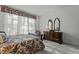 Bedroom with a dark wood sleigh bed, dresser, and window seating at 5503 Rutherford Close, Pittsboro, NC 27312