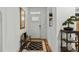 Bright entryway with wood floors, bench, and mirror at 5503 Rutherford Close, Pittsboro, NC 27312