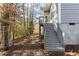 House exterior showcasing gray siding and wooden stairs at 5503 Rutherford Close, Pittsboro, NC 27312