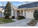 Gray home with white garage door and brick walkway at 5503 Rutherford Close, Pittsboro, NC 27312