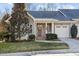 Gray two-story home with white garage door and landscaping at 5503 Rutherford Close, Pittsboro, NC 27312