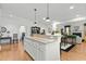 Spacious kitchen boasts an island, granite countertops, and white cabinetry at 5503 Rutherford Close, Pittsboro, NC 27312