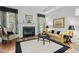 Living room with fireplace, hardwood floors, and comfortable seating at 5503 Rutherford Close, Pittsboro, NC 27312