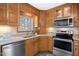 Modern kitchen with stainless steel appliances and ample wood cabinetry at 6814 Lockwood Dr, Durham, NC 27712