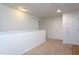 Upstairs hallway with two doors and neutral carpeting at 6817 Osprey Landing Dr, Wendell, NC 27591