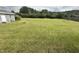 Large grassy backyard with shed and fire pit at 7513 Orchard Crest Ct, Apex, NC 27539