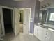 Elegant bathroom boasts double vanity and access to bedroom at 7513 Orchard Crest Ct, Apex, NC 27539