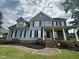 Two-story house with blue siding, black shutters, and a large front yard at 7513 Orchard Crest Ct, Apex, NC 27539