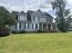 Two-story house with blue siding, black shutters, and a large front yard at 7513 Orchard Crest Ct, Apex, NC 27539
