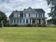 Two-story house with blue siding, black shutters, and a spacious lawn at 7513 Orchard Crest Ct, Apex, NC 27539