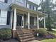 Two-story home's front entrance with brick steps and stone accents at 7513 Orchard Crest Ct, Apex, NC 27539