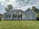 Back of house, showcasing blue siding and sunroom at 7513 Orchard Crest Ct, Apex, NC 27539