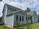 Two-story house with blue siding, sunroom and landscaping at 7513 Orchard Crest Ct, Apex, NC 27539
