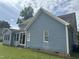 Rear view of two-story house, blue siding, sunroom at 7513 Orchard Crest Ct, Apex, NC 27539