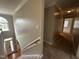 Upstairs hallway with carpet and railing at 7513 Orchard Crest Ct, Apex, NC 27539