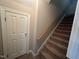 Upstairs hallway with carpet and door to storage at 7513 Orchard Crest Ct, Apex, NC 27539