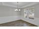 Bright dining room with chandelier and wainscoting at 85 Kissington Way, Benson, NC 27504