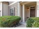 Inviting front entrance with a brown door and lush landscaping at 8916 Buffalo Gourd Ln, Angier, NC 27501